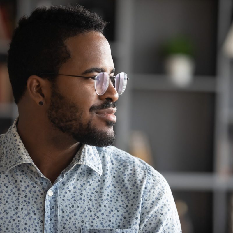 Pensive,Young,African,American,Man,In,Glasses,Look,In,Distance