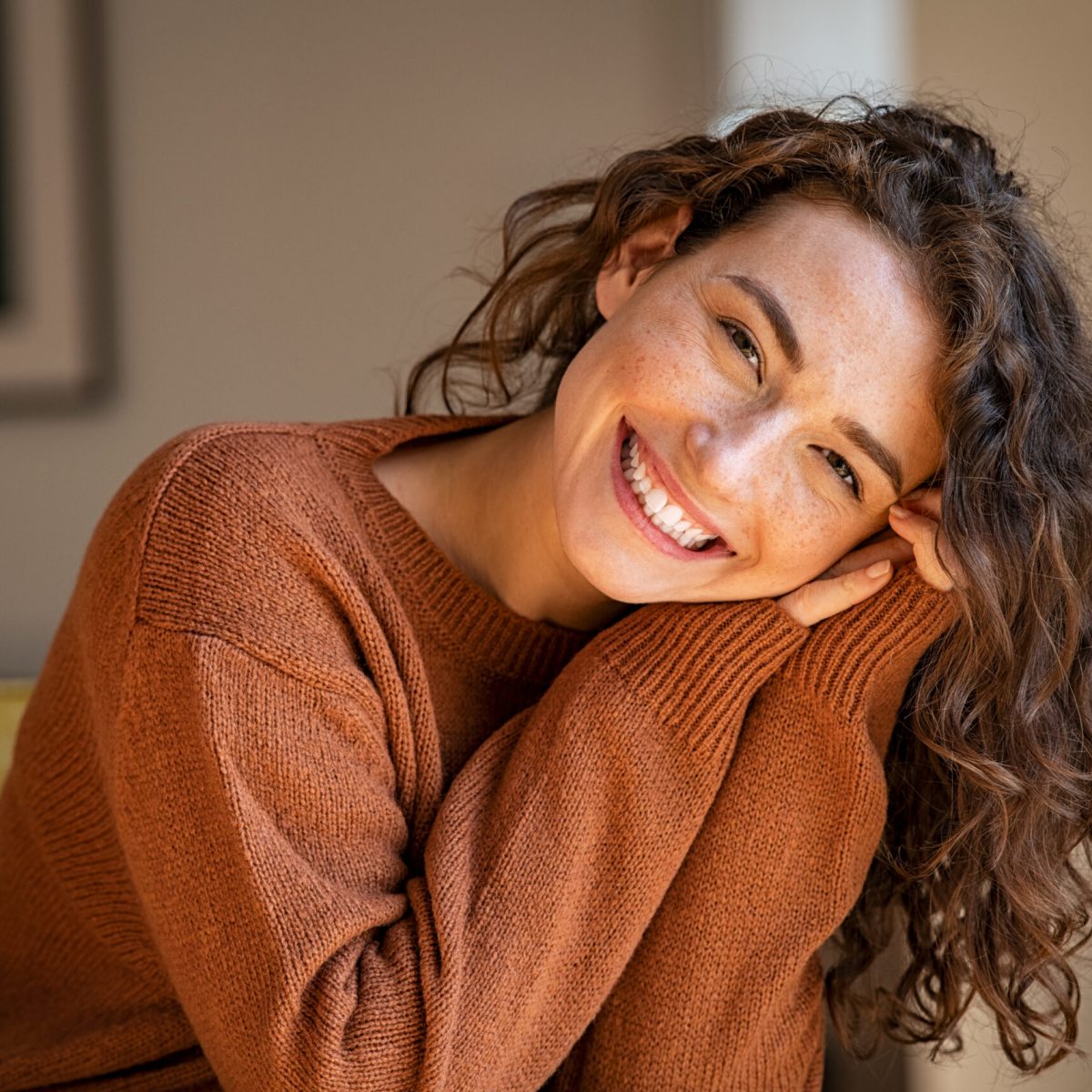 Happy,Young,Woman,Sitting,On,Sofa,At,Home,And,Looking Happy,Young,Woman,Sitting,On,Sofa,At,Home,And,Looking